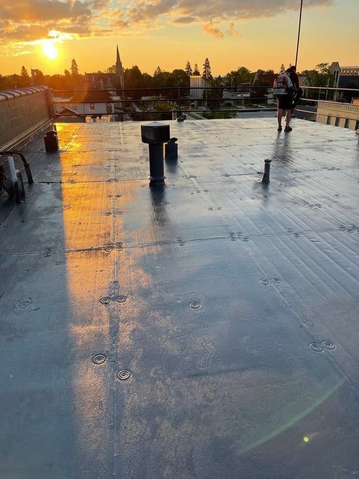 Fabric reinforced membrane system before restoration showing weathered condition and need for professional restoration