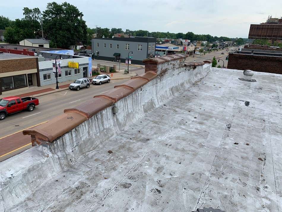 Commercial membrane roofing system before restoration showing wear and deterioration requiring professional restoration