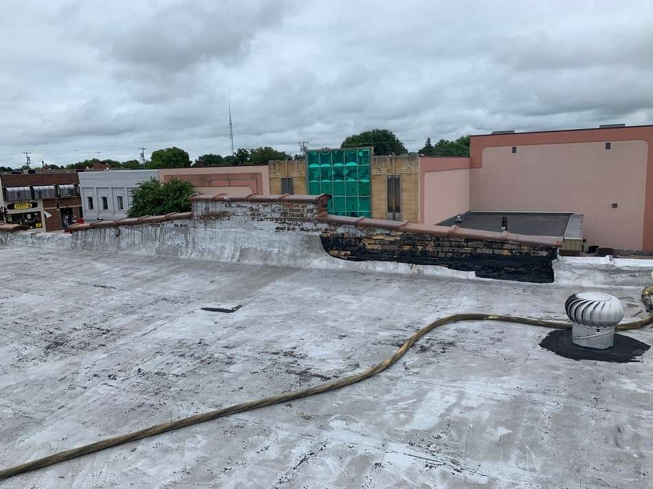 Membrane roofing system before restoration showing weathered condition requiring professional restoration services