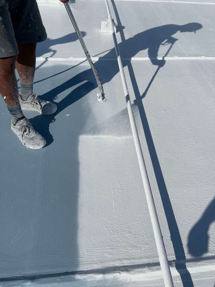 Membrane restoration application by certified professionals showing quality installation and superior coating materials