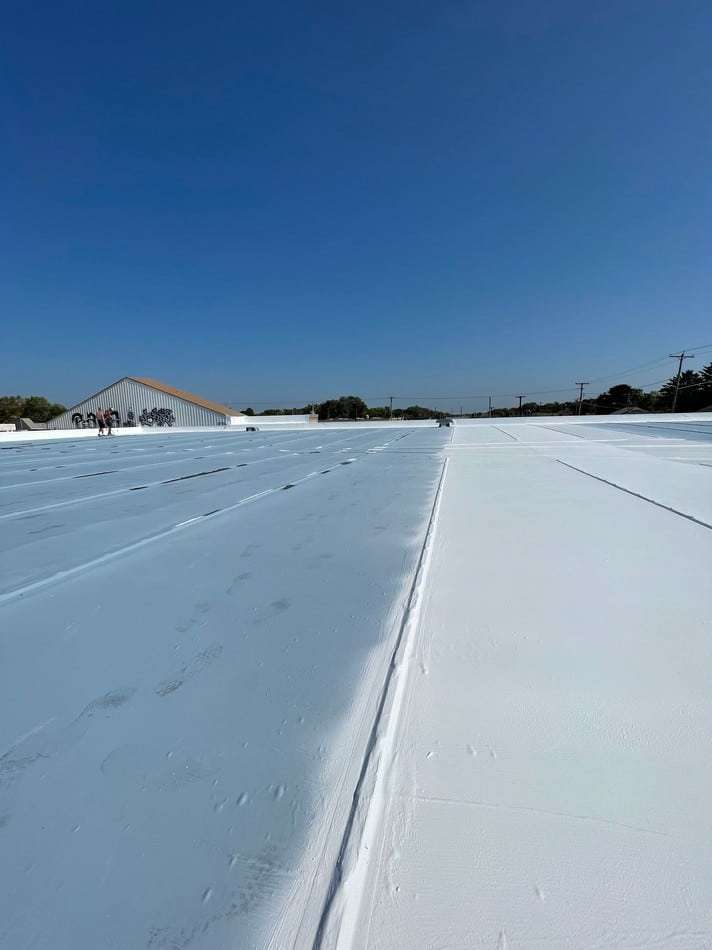 Membrane restoration in progress showing professional application methods and superior coating system for weather resistance
