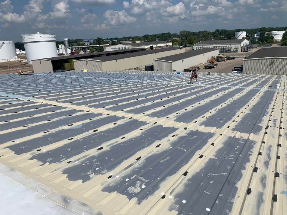 Metal roof restoration project showcasing expert application and energy-efficient coating solutions