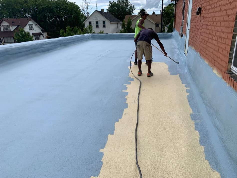 Spray foam roofing work in progress by Roof Tech LLC showing seamless application and professional techniques