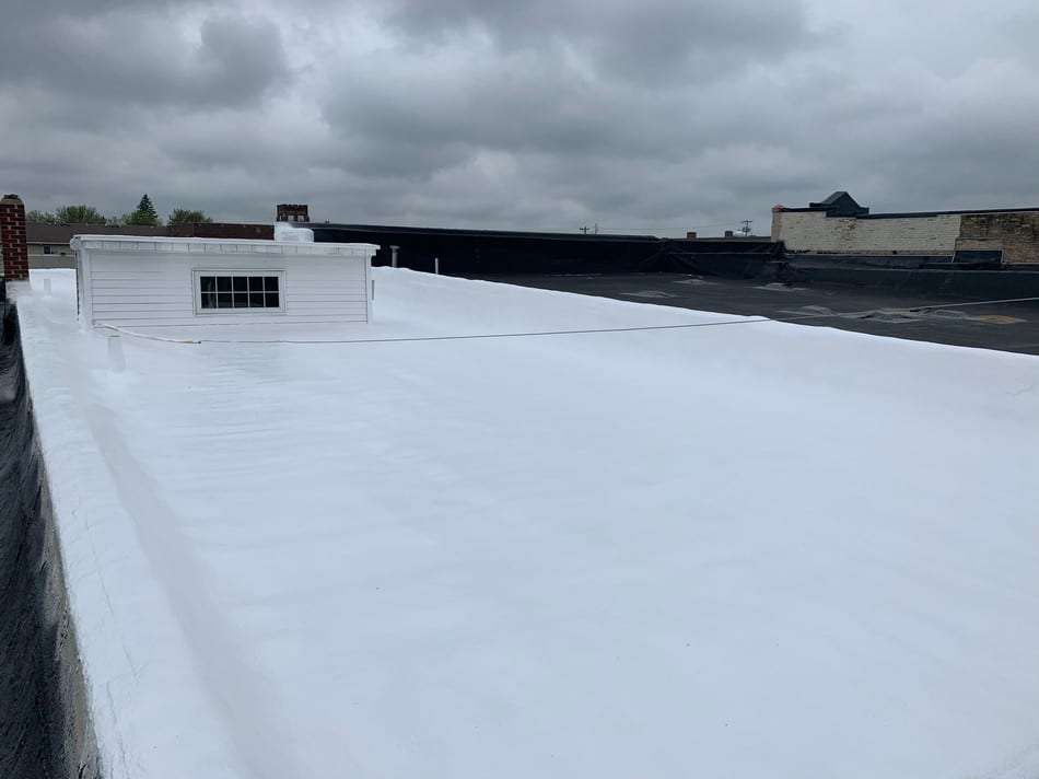 Professional spray foam roofing system installation demonstrating lightweight application and superior weather protection