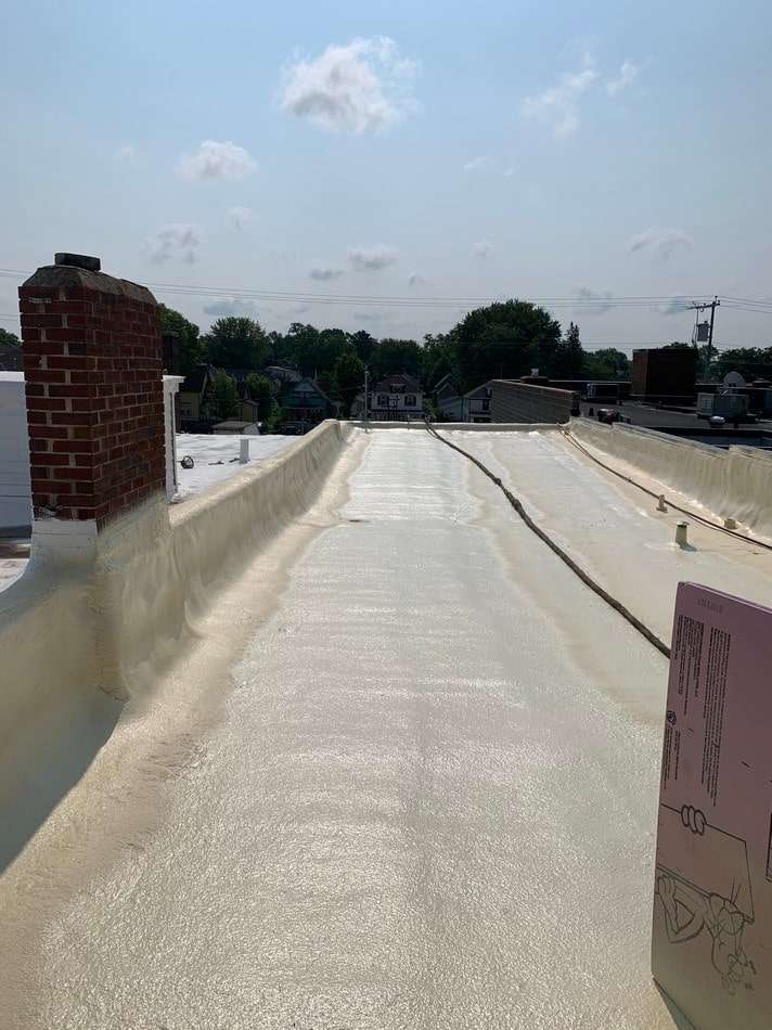 Professional spray foam application showing seamless waterproof barrier and energy-efficient insulation properties