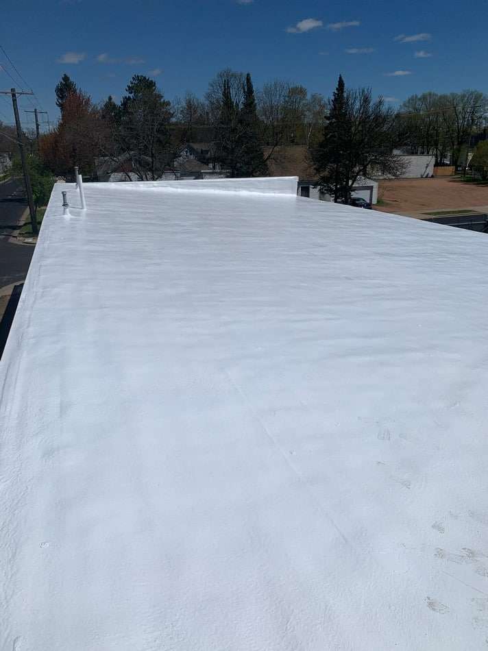 Spray foam roofing system application demonstrating seamless waterproof barrier and superior insulation capabilities