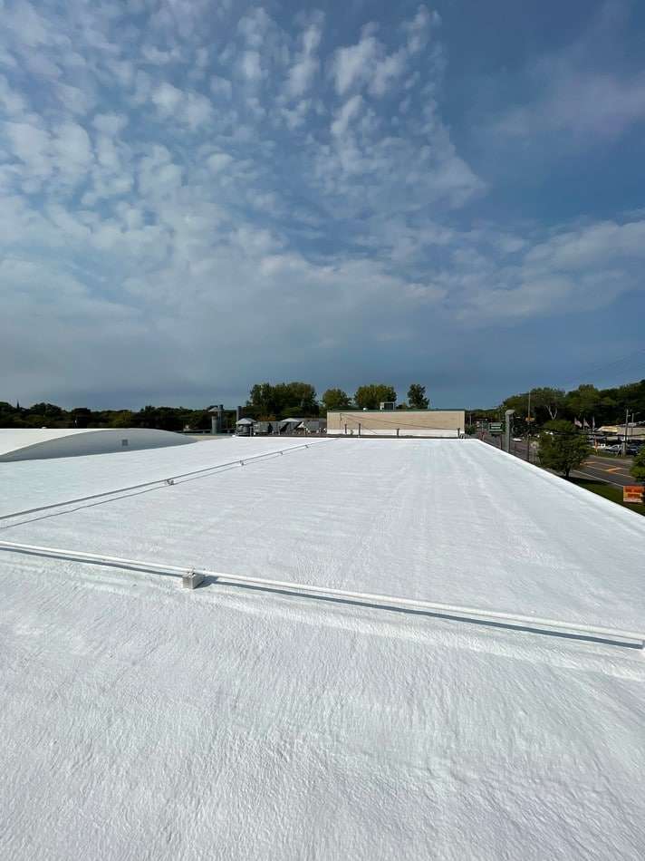 Professional spray foam installation showing expert application methods and energy-efficient roofing solution