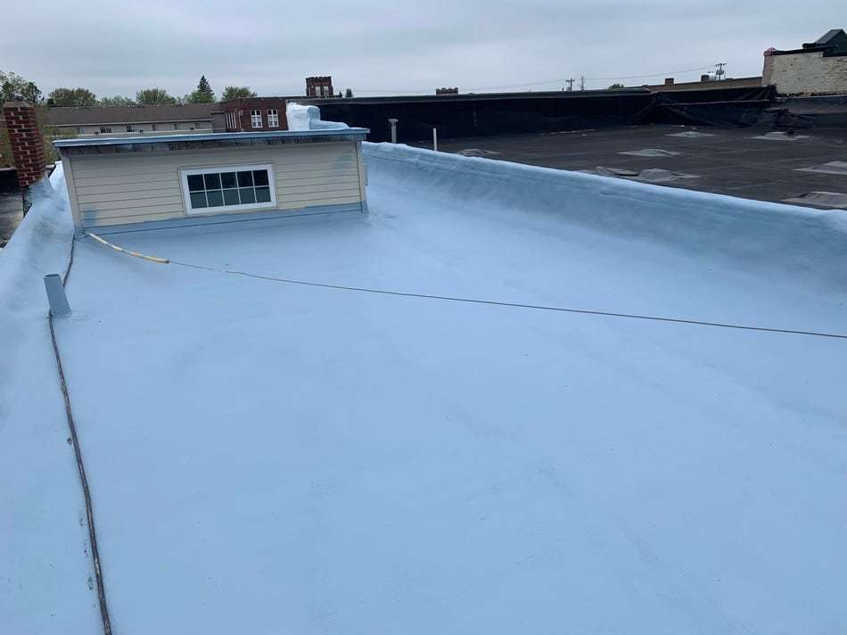 Spray foam roofing work showing professional application techniques and long-term protection benefits